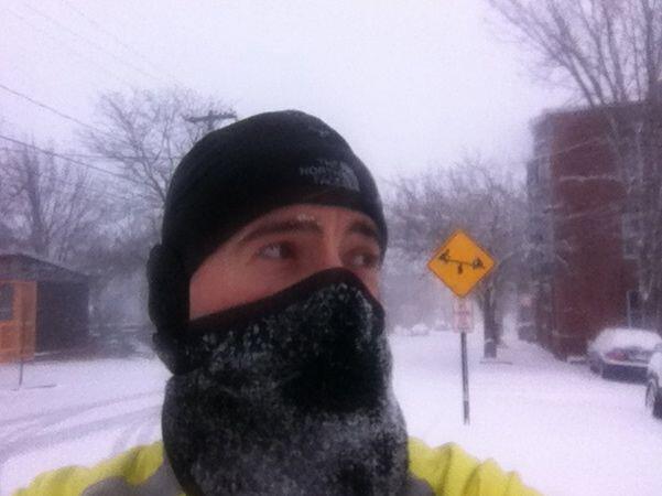 Brian with his face covered after a snow storm